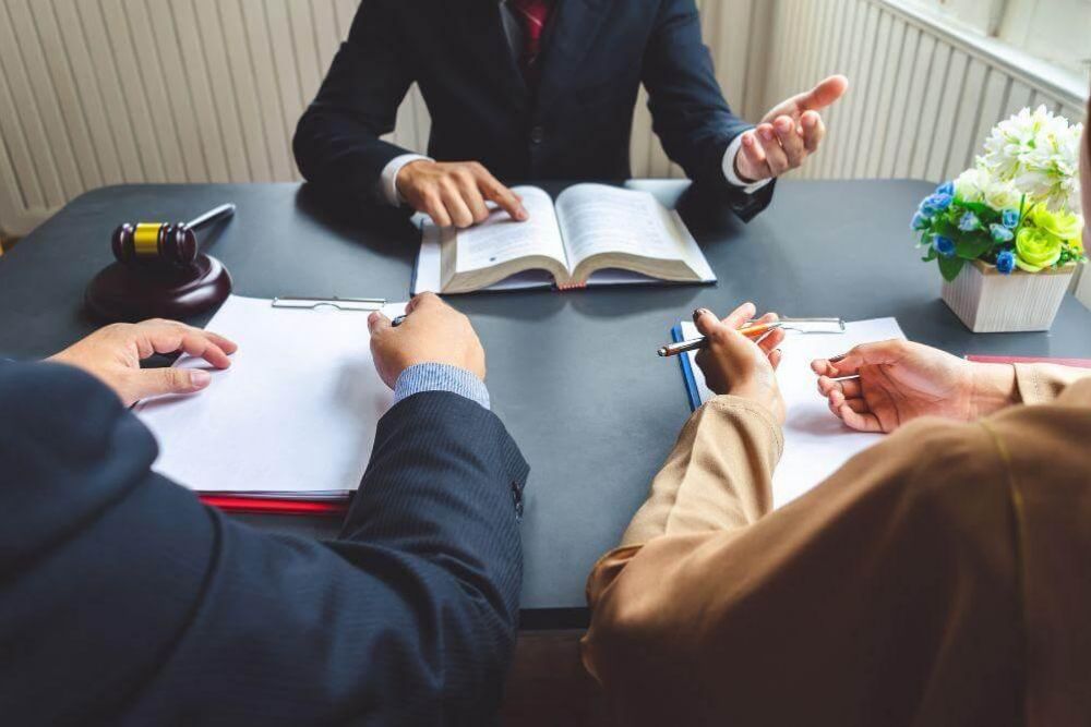 Two people reviewing documents at a table