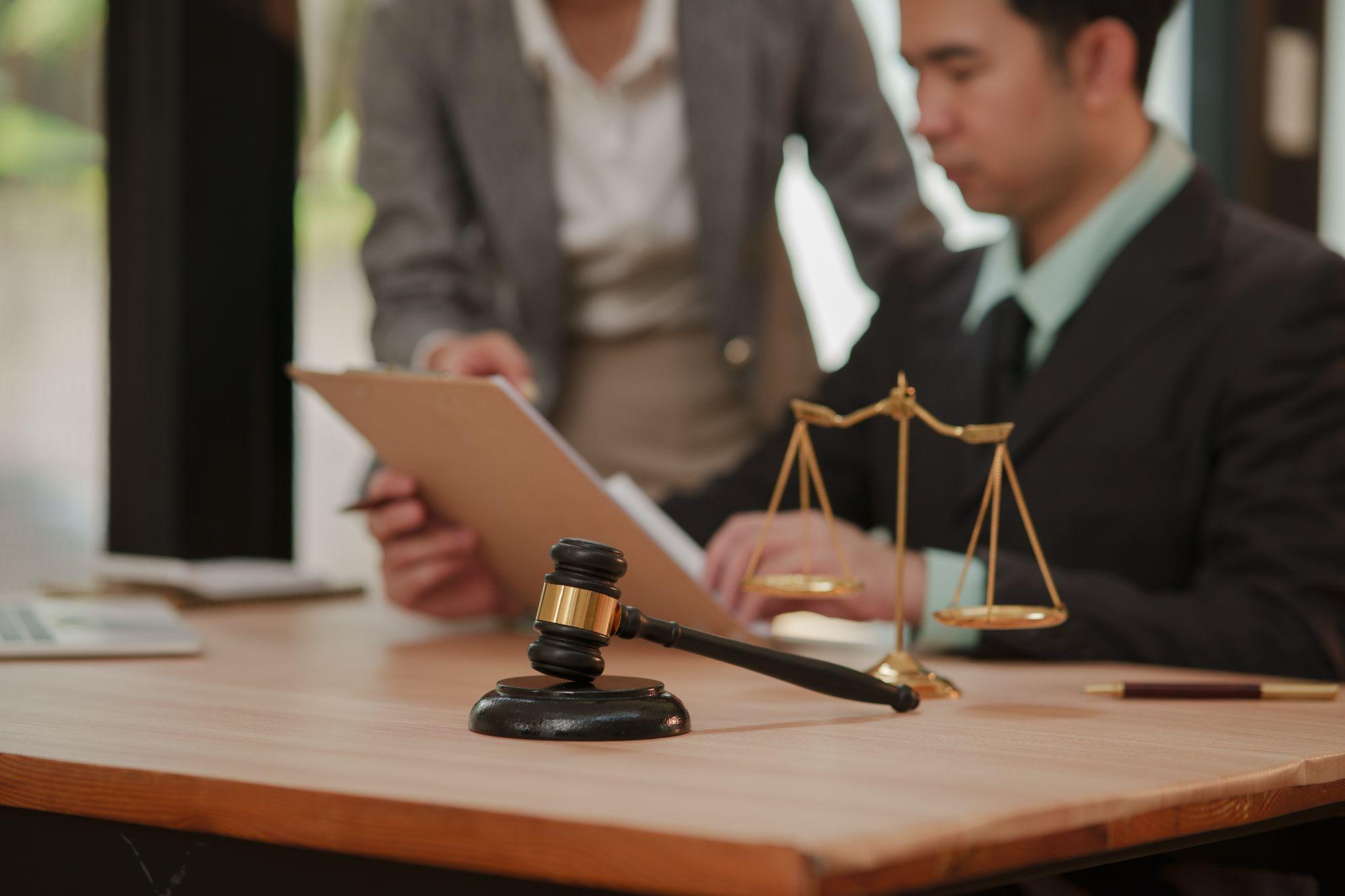 Two people with a scale of justice discussing Texas