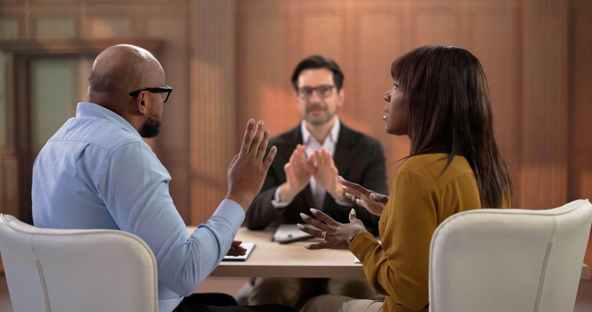 Clients clapping around a table, celebrating a