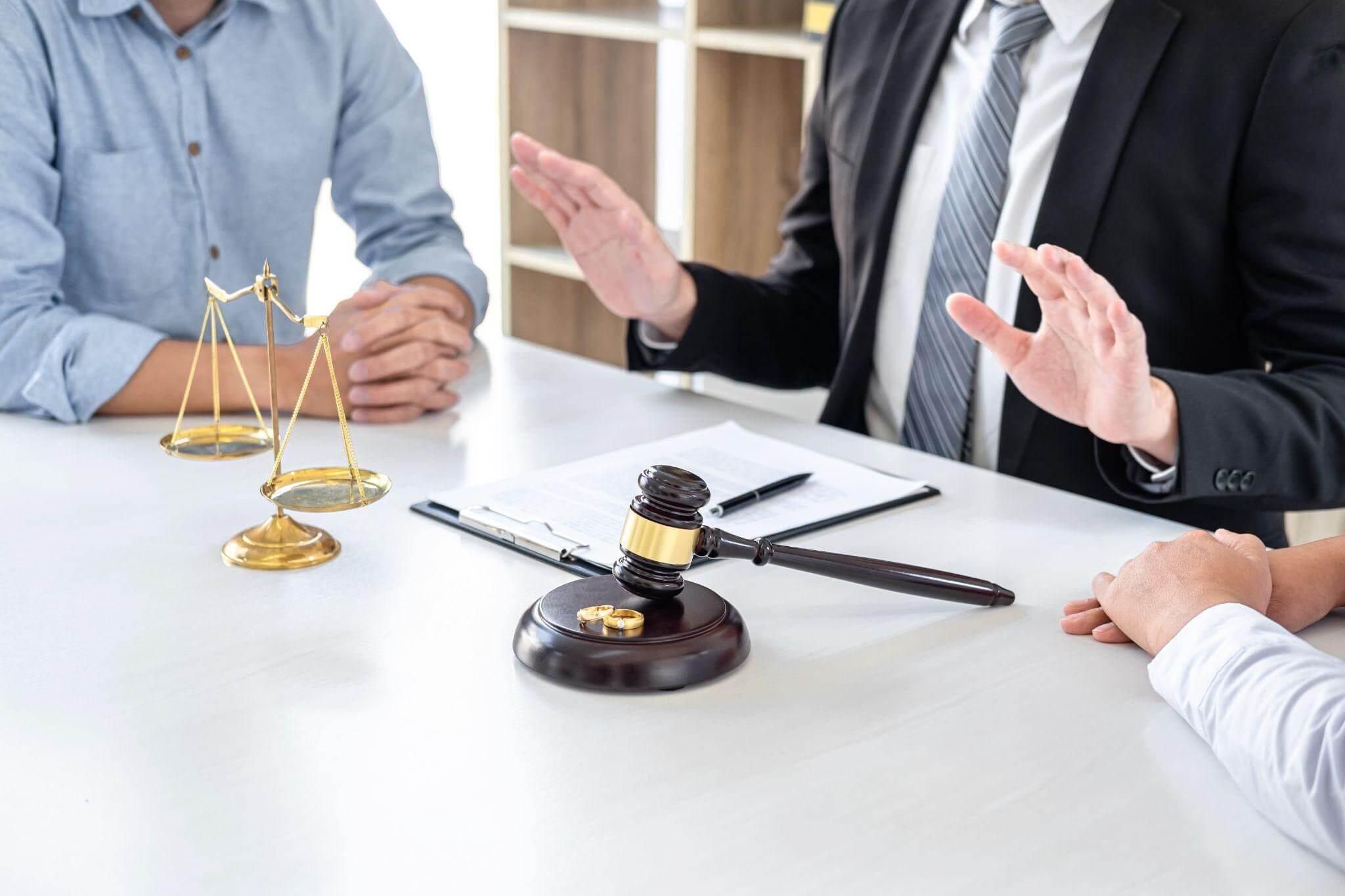 Judge and two people at a table during a