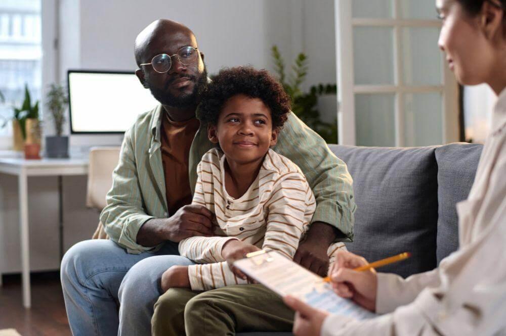 Happy family of three sitting on a couch