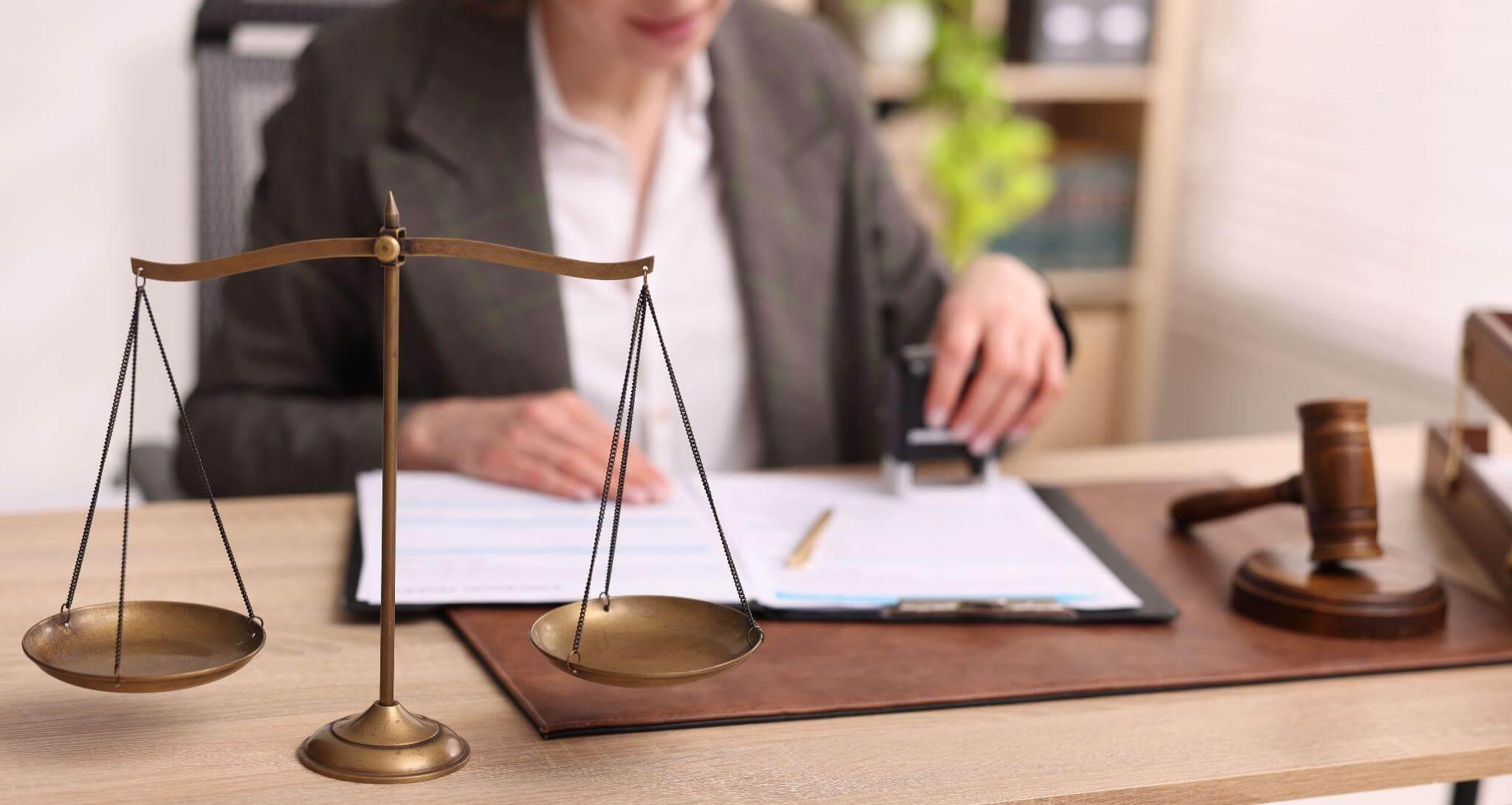 Woman at desk with scale and pen,